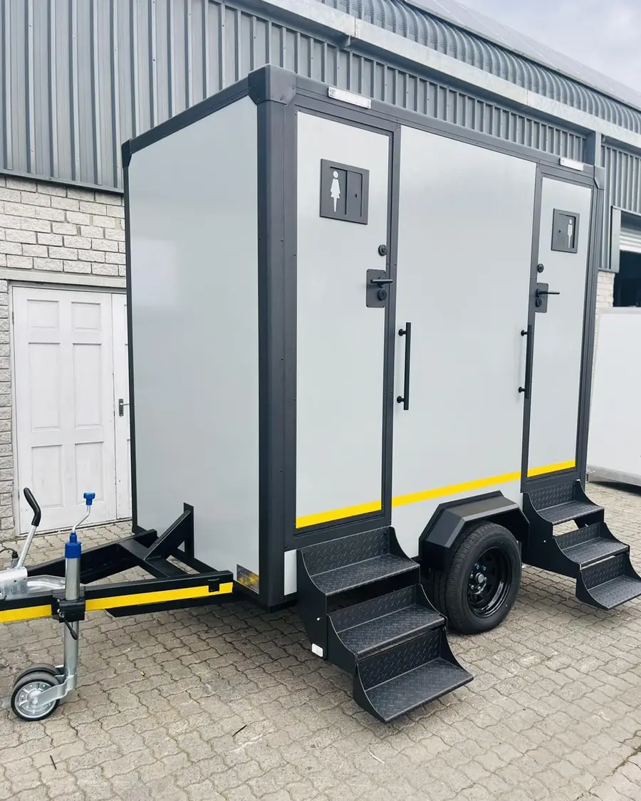 Two-stall white restroom trailer with steps